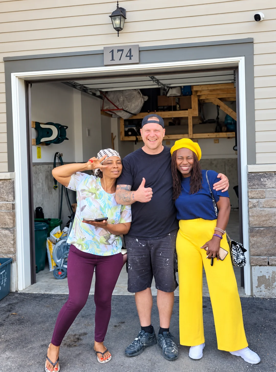 Jordan of Man Handy Inc. with two happy homeowners after finishing a garage project
